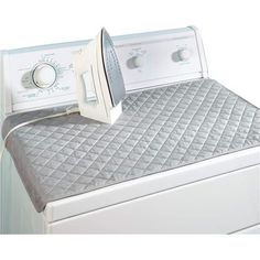 an electric dryer sitting on top of a bed