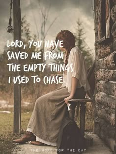 a woman sitting on top of a chair next to a stone wall with the words god is merciful