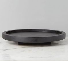 a black tray sitting on top of a marble counter