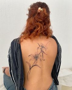 a woman with a flower tattoo on her back