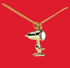 a gold necklace with a dog on it's head and a chain around the neck