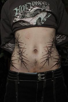 a person with tattoos on their stomach