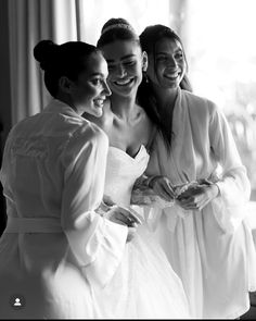 three women in white dresses standing next to each other