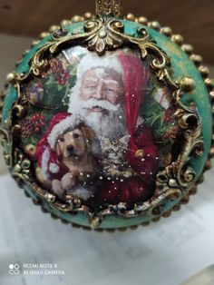 a christmas ornament with a dog and santa clause on it