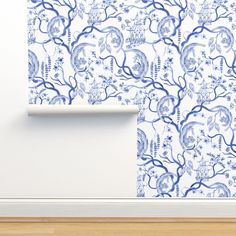 a blue and white wallpaper with trees on it