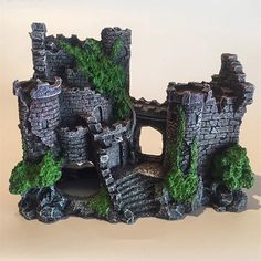 a toy castle with moss growing out of it