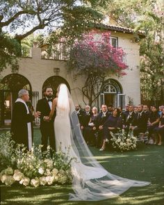 a bride and groom standing in front of an outdoor ceremony