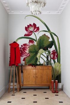 a room with a large flower mural on the wall