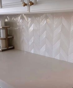 a white counter top in a kitchen next to cabinets