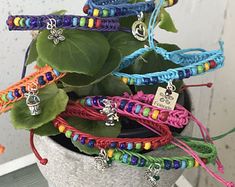 a potted plant filled with lots of colorful bracelets