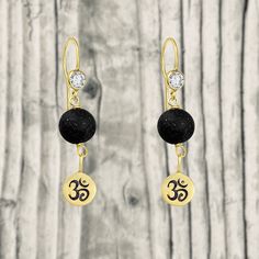 Gold Filled Yoga Inspired Lava Stone Earrings with Ohm Charm to Hear the Sound of the Universe "What a delight these earrings bring me! I drop a few droplets of my essential oil of choice (usually lavender) and go about my day, relaxed and feeling just lovely!" said Aria Morgan, yoga instructor.﻿ Ohm, Om or Aum is a sacred sound that is known as the sound of the universe. It is the entire cosmos, whatever we see, we touch, hear and feel. It is the eternal song of the Divine, continuously resound Spiritual Black Earrings For Gift, Black Spiritual Earrings For Gift, Hypoallergenic Spiritual Dangle Earrings, Spiritual Hypoallergenic Earrings As Gift, Yoga Instructor, Lava Stone, Yoga Inspiration, The Sound, Stone Earrings