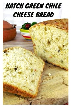 two pieces of bread sitting on top of a wooden cutting board with text overlay that reads hatch green chile cheese bread