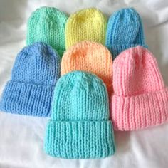 six knitted hats laying on top of each other