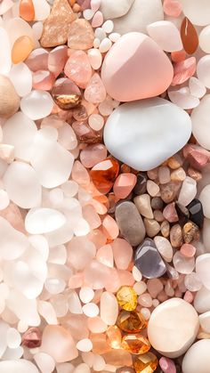 many different colored rocks and pebbles on the ground