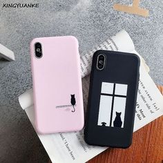 two iphone cases sitting on top of each other next to an open window with a cat in it