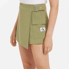 Calvin Klein Jeans mini skort.Green woven fabric.93% polyester, 7% elastane.Buckle detail, side flap pocket.Machine wash.Designer colour: Dark Juniper Fitted Mini Shorts With Side Pockets, Trendy Fitted Cargo Shorts, Fitted Cargo Pocket Skort, Fitted Skort With Cargo Pockets In Short Length, Summer Elastane Skort With Pockets, Fitted Short Length Skort With Cargo Pockets, Short Elastane Skort With Pockets, Elastane Skort With Pockets, Spring Cargo Pocket Short Skort