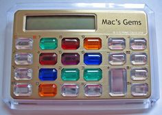 a calculator with many different colored stones on it