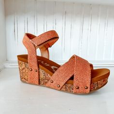 The Shirley Wedge will add a pop to any outfit. These studded wedges feature a cork detailed wedge and super comfortable sole! Synthetic upper Hook-and-loop closure Lightly cushioned footbed 2-1/2" wedge heel 1/2" of Padding for Comfort! Fits true to size. Spring Cork Wedge Sandals With Round Toe, Casual Cork Platform Wedge Sandals, Cork Wedge Sandals With Cushioned Footbed, Cork Open Toe Wedge Sandals With Textured Footbed, Cushioned Cork Wedge Sandals, Adjustable Round Toe Wedge Sandals With Cork-bed Midsoles, Cushioned Cork Wedge Sandals With Round Toe, Cork Wedge Sandals With Textured Footbed, Swim Jewelry