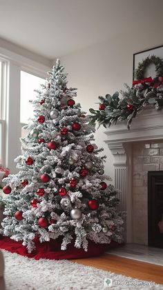 a white christmas tree with red and silver ornaments