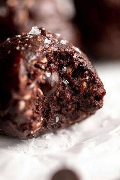 chocolate cookies with sea salt and flecks are on a baking sheet, ready to be eaten