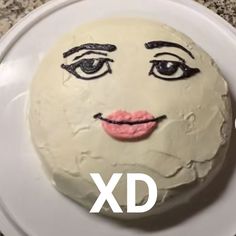 a white cake with a face drawn on it