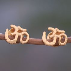 Representing a meditative mantra used in both Hindu and Buddhist traditions om is depicted in this pair of stud earrings from Bali. Asmara Putra designs these earrings which are crafted of sterling silver bathed in 18k gold. Buddhist Traditions, Jewelry Workshop, Sterling Silver Stud Earrings, Silver Stud Earrings, Beaded Stretch Bracelet, Jewelry Packaging, Sterling Silver Studs, Sterling Silver Earrings Studs, Sterling Silver Bead