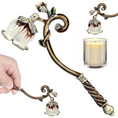 a candle holder with an ornate design on it and a hand holding the candle next to it