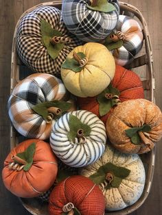 a basket filled with pumpkins sitting on top of a wooden floor