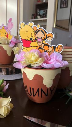 winnie the pooh flower pot with flowers in it