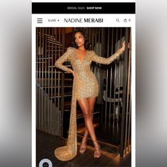 a woman in a gold sequin dress standing next to a metal gate and posing for the camera