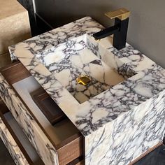 a bathroom sink made out of marble and wood