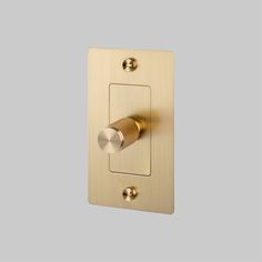 a light switch with two knobs on the front and side of it, in an antique brass finish