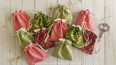 six small green and red bags with white checkered draws on them, tied together