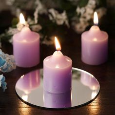 three lit candles sitting on top of a plate