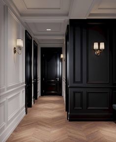 an empty hallway with black walls and wood flooring