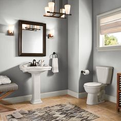 a bathroom with green walls and white fixtures