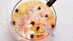 a glass bowl filled with ice and lemon slices