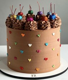 a cake with chocolate frosting and hearts on it