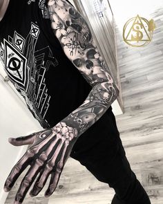 a man with tattoos on his arm and hand