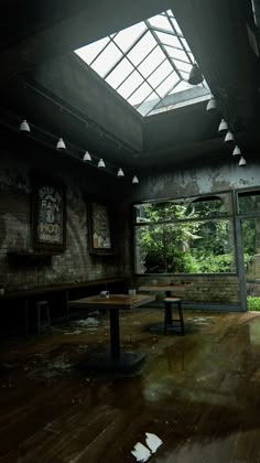 an empty room with wooden floors and skylights