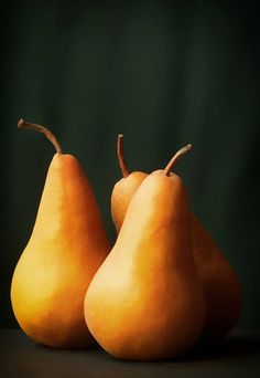 three pears sitting on top of a table