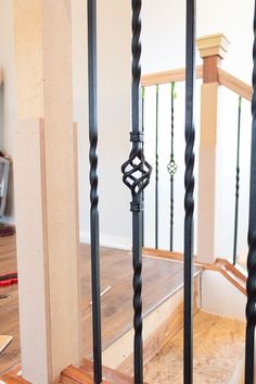 an image of a stair case with wood and wrought iron railings in the background