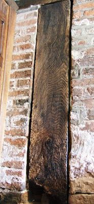 an old brick wall with wood in it