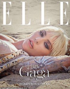 a woman laying on top of a sandy beach