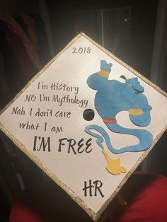 a white graduation cap with an image of a blue dog on it and the words, i'm free hrr