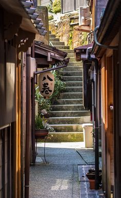 an alley way with steps leading up and down