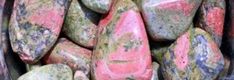 colorful rocks are stacked in a bucket