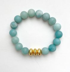 These gorgeous Jade bracelets are beautiful on their own, stacked together, or added to your existing stack. Jade bracelets are made from 10mm matte jade beads with gold-brushed accent beads. This listing is for one bracelet. Bracelets are handmade on strong stretch cord and approximately 7 inches in length, which fits small to medium adult wrists. Custom sizing is available! If you have concerns about sizing, please message me so we can discuss the perfect fit your bracelets. Gold Beaded Bracelets With Amazonite Round Beads, Gold Amazonite Round Beaded Bracelets, Everyday Jade Beaded Bracelets With Round Beads, Amazonite Beaded Bracelets For Everyday, Gold Amazonite Beaded Bracelets, Amazonite Gemstone Beads Stretch Bracelet, Jade Bracelet, Jade Beads, Cute Packaging