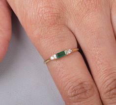 Emeralds are often associated with love and fidelity. Wearing this gemstone is believed to strengthen existing relationships, promoting loyalty and unity between partners. It can also attract new love into your life, as it radiates an energy of unconditional love and compassion. Gemstone: Lab Grown Emerald Shape/Size: Octagon 6x2.5MM  Finish Type: White rhodium/ yellow gold plating/rose gold plating / Solid14K Gold also available Ring Size: US Ring sizes 3-12  Metal Type: 925 Sterling Silver / S Elegant Three Stone Birthstone Ring In 14k Gold, 14k Gold Three Stone Baguette Cut Jewelry, Elegant Emerald Three-stone Birthstone Ring, Fine Jewelry Emerald Three Stone Promise Ring, Fine Jewelry Three Stone Emerald Promise Ring, Fine Jewelry Three Stone Emerald Ring For Promise, Elegant Three Stone Birthstone Promise Ring, Three Stone Emerald And Diamond Ring For Gift, Three-stone Emerald Diamond Ring As Gift