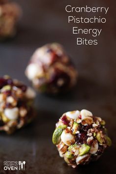 cranberry pistachio energy bites on a table with the title above it